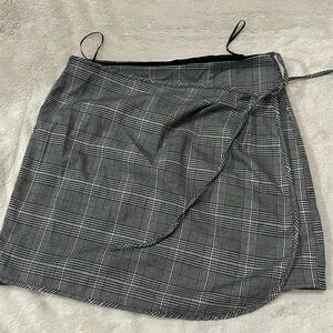 It’s a tie up mini skirt with a button and an extra button for length if needed